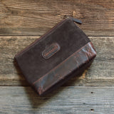 Dixonville Suede Makeup Bag made from soft suede with a compact, elegant design for organizing makeup and beauty essentials