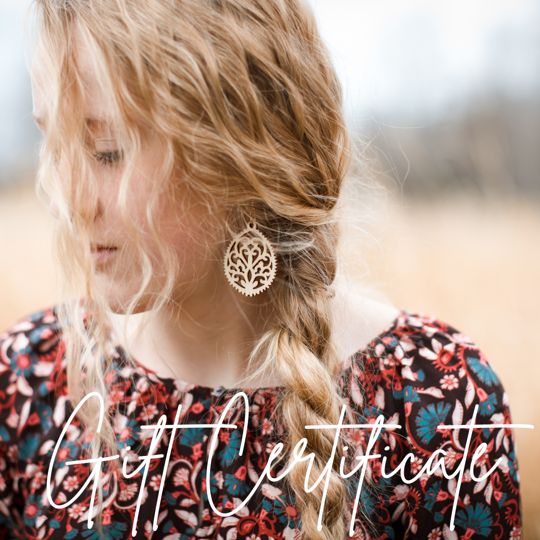 A person with a floral garment wearing an earring, with the text 'Gift Certificate' overlaid on the image.